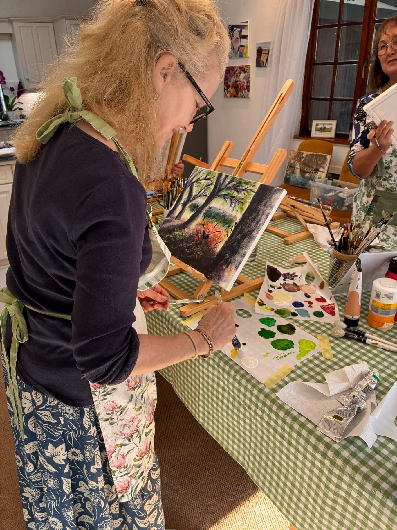 Painter working at an easel in the studio